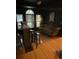 This elegant living room has black walls, wooden floors, and a bar with a large window, perfect for entertaining at 112 Amanda Cir, Goose Creek, SC 29445