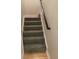 Carpeted stairs with wooden handrail and hardwood floor landing at 112 Amanda Cir, Goose Creek, SC 29445