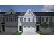 Gray townhome exterior with a two-car garage and a modern architectural design at 114 Brown Swiss Cir, Summerville, SC 29483