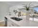 Modern kitchen featuring a white countertop island with a stainless steel sink and view to the dining area at 114 Brown Swiss Cir, Summerville, SC 29483