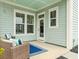 Relaxing covered back porch with comfortable seating, perfect for outdoor enjoyment at 115 Winding Branch Dr, Summerville, SC 29486