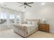 Sunny bedroom with a large bed, ceiling fan, white trim and bright windows at 115 Winding Branch Dr, Summerville, SC 29486