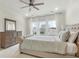 Well-lit bedroom with a large bed, dresser, ceiling fan and bright windows at 115 Winding Branch Dr, Summerville, SC 29486