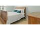 Bedroom with tan carpet, wooden bed frame and blue pillows at 115 Winding Branch Dr, Summerville, SC 29486