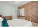 Charming bedroom featuring a rustic wood bed frame and exposed brick accent wall at 115 Winding Branch Dr, Summerville, SC 29486