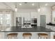 Open-concept kitchen island with bar seating, stainless steel appliances, and modern white cabinetry at 115 Winding Branch Dr, Summerville, SC 29486