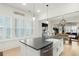 Bright kitchen features an island with a sink, stainless steel dishwasher, and an open layout into the dining area at 115 Winding Branch Dr, Summerville, SC 29486
