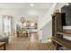 Open-concept living room and dining area with hardwood floors, a wooden TV stand, and light-colored walls at 115 Winding Branch Dr, Summerville, SC 29486