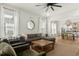 Bright living room with large windows, a ceiling fan, decorative mirror, comfortable seating, and an open floor plan at 115 Winding Branch Dr, Summerville, SC 29486
