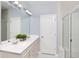 Bright bathroom with a dual vanity, large mirror, and a walk-in shower featuring glass doors at 117 Royal Cainhoy Way, Huger, SC 29450