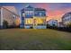 Spacious backyard with a well-maintained lawn and a view of the home's back porch at 1251 Weather Helm Dr, Mount Pleasant, SC 29466