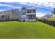 Expansive backyard of a blue, two-story home, featuring a well-manicured lawn and dark, wooden fence at 1251 Weather Helm Dr, Mount Pleasant, SC 29466