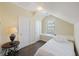 Cozy bedroom with a white bed and stylish round side table under a window in the eaves at 1251 Weather Helm Dr, Mount Pleasant, SC 29466
