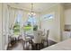 Bright dining area featuring a chandelier, windows with sheer curtains and seating for six at 1251 Weather Helm Dr, Mount Pleasant, SC 29466