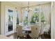 Bright dining area featuring a chandelier, windows with sheer curtains and seating for six at 1251 Weather Helm Dr, Mount Pleasant, SC 29466