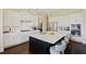 A gourmet kitchen featuring white cabinets, stainless steel appliances, and a large marble island with seating at 1251 Weather Helm Dr, Mount Pleasant, SC 29466
