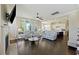 Open-concept living room with hardwood floors, fireplace, and abundant natural light at 1251 Weather Helm Dr, Mount Pleasant, SC 29466
