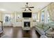 Spacious living room featuring a fireplace, hardwood floors, and large windows at 1251 Weather Helm Dr, Mount Pleasant, SC 29466