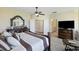 A large main bedroom features a king bed, dresser with a large mirror, and doors to a full bathroom at 1251 Weather Helm Dr, Mount Pleasant, SC 29466
