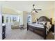 A serene main bedroom features a large bed, sitting area by the windows, and ceiling fan for added comfort at 1251 Weather Helm Dr, Mount Pleasant, SC 29466