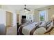 A luxurious main bedroom boasts a large bed, ceiling fan, and seamless access to a spacious walk-in shower at 1251 Weather Helm Dr, Mount Pleasant, SC 29466