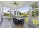 Relaxing outdoor porch with ceiling fan, dining table, and built in bench seating at 1251 Weather Helm Dr, Mount Pleasant, SC 29466