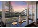 Screened in porch with place settings on an outdoor table overlooking the spacious backyard at 1251 Weather Helm Dr, Mount Pleasant, SC 29466