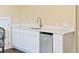 Wet bar area with white cabinets, stainless steel mini fridge, and a white marble-style countertop at 1251 Weather Helm Dr, Mount Pleasant, SC 29466
