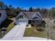 An aerial view showcases the well-maintained house with a long driveway, lush lawn and mature landscaping at 126 Citrea Dr, Summerville, SC 29483