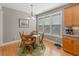 Cozy breakfast nook with a wood table, seating for four, and natural light from the large windows at 126 Citrea Dr, Summerville, SC 29483