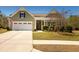 Charming single Gathering home featuring a spacious driveway and manicured lawn with mature shrubs at 126 Citrea Dr, Summerville, SC 29483
