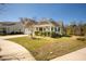 Charming single-story home featuring a manicured lawn, inviting front porch, and lush landscaping at 126 Citrea Dr, Summerville, SC 29483