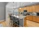 Bright kitchen features a granite island with barstool seating, stainless steel appliances, and wooden cabinetry at 126 Citrea Dr, Summerville, SC 29483