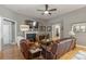 Open-concept living room boasting hardwood floors, a fireplace, and comfortable seating with views of the bedroom at 126 Citrea Dr, Summerville, SC 29483