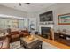 Cozy living room with a fireplace, comfortable leather seating, and an open view to the bedroom at 126 Citrea Dr, Summerville, SC 29483