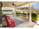 Front porch featuring red rocking chairs with cozy pillows and a textured blue rug at 126 Citrea Dr, Summerville, SC 29483