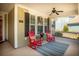 Charming front porch featuring inviting red rocking chairs, ceiling fan, and seasonal decorations at 126 Citrea Dr, Summerville, SC 29483