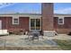 Brick home's backyard featuring a patio with table and chairs, plus outdoor furniture at 1264 Fort Dr, Hanahan, SC 29410