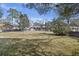 Spacious backyard featuring a patio and the brick home in a park-like setting at 1264 Fort Dr, Hanahan, SC 29410