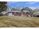 Spacious backyard featuring a patio with a table and chairs, plus the brick home at 1264 Fort Dr, Hanahan, SC 29410