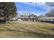 Expansive backyard featuring a red brick home with a chimney and a well-maintained lawn at 1264 Fort Dr, Hanahan, SC 29410