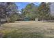 Spacious backyard with mature trees, a storage shed, and plenty of room for outdoor activities at 1264 Fort Dr, Hanahan, SC 29410
