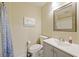 Bathroom with tub and shower combination, toilet, and vanity with flamingo-themed artwork at 1264 Fort Dr, Hanahan, SC 29410