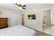 Inviting bedroom with a ceiling fan, closet, TV, and an ensuite bathroom with a tiled walk-in shower at 1264 Fort Dr, Hanahan, SC 29410