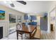 Bright dining area with table, chairs, a fireplace, and sliding glass doors to the backyard and a full kitchen at 1264 Fort Dr, Hanahan, SC 29410