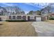 Well-maintained brick home with a large front yard, mature landscaping, and attached garage at 1264 Fort Dr, Hanahan, SC 29410