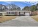 Brick ranch-style home featuring black shutters, a white front door, and an attached garage at 1264 Fort Dr, Hanahan, SC 29410