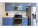 Charming kitchen with stainless steel appliances, sleek countertops, and bright blue cabinetry at 1264 Fort Dr, Hanahan, SC 29410
