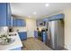 Updated kitchen with stainless steel appliances, white countertops, and stylish blue cabinetry at 1264 Fort Dr, Hanahan, SC 29410
