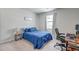 Cozy bedroom featuring a comfortable bed with blue bedding, a work station, and natural light from the window at 131 Brant Dr, Summerville, SC 29483